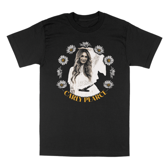A black short-sleeve crewneck t-shirt featuring a front graphic print of Carly Pearce surrounded by white daisies, with her name printed in yellow at the bottom.